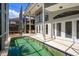 In-ground swimming pool with screened-in enclosure, patio, and tall windows at 334 N Shadowbay Blvd, Longwood, FL 32779