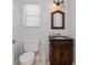Charming powder room features a wood vanity with granite countertop and decorative mirror, ideal for guests at 334 N Shadowbay Blvd, Longwood, FL 32779