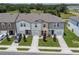 Charming townhomes featuring varied exterior colors, attached garages, and manicured lawns at 3435 Vesara Dr, Davenport, FL 33837