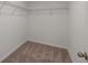 An empty walk-in closet that has a wire shelving system and neutral carpet at 3435 Vesara Dr, Davenport, FL 33837