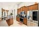 Well-equipped kitchen with stainless steel appliances and wooden cabinetry, modern and functional at 3451 Players Point Loop, Apopka, FL 32712