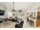Open living area with tile floors, neutral walls, ceiling fan, and sliding glass doors to the backyard at 3451 Players Point Loop, Apopka, FL 32712