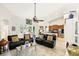 Spacious living room featuring tile floors, neutral walls, ceiling fan, and views of the backyard at 3451 Players Point Loop, Apopka, FL 32712