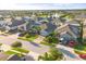 Aerial view of a residential neighborhood with manicured lawns, mature trees, and community lake at 3925 Green Sabal Dr, Orlando, FL 32824