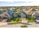 Neighborhood aerial showcasing homes with solar panels, manicured lawns, and lakeside community at 3925 Green Sabal Dr, Orlando, FL 32824