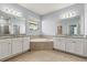 Bathroom featuring a corner soaking tub, dual sinks, and modern finishes for a luxurious feel at 3925 Green Sabal Dr, Orlando, FL 32824