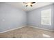 Bright bedroom featuring a neutral color palette, ceiling fan, and a window for natural light at 3925 Green Sabal Dr, Orlando, FL 32824