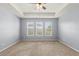 Spacious bedroom with three large windows and a ceiling fan, offering plenty of natural light at 3925 Green Sabal Dr, Orlando, FL 32824