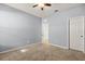 Bedroom with neutral carpet and ceiling fan, showcasing the doorway and door to adjacent spaces at 3925 Green Sabal Dr, Orlando, FL 32824