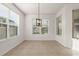 Dining area with tile flooring, modern chandelier and natural light from three windows at 3925 Green Sabal Dr, Orlando, FL 32824