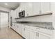 Sleek kitchen with stainless steel appliances, granite counters, white cabinets and ample storage space at 3925 Green Sabal Dr, Orlando, FL 32824