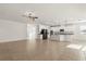 Bright, open-concept kitchen and living area with tile flooring, white cabinets, and a large island at 3925 Green Sabal Dr, Orlando, FL 32824