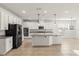 Open kitchen featuring stainless appliances, a large island, white cabinets and lots of room to entertain at 3925 Green Sabal Dr, Orlando, FL 32824