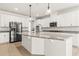 Stylish kitchen featuring a large center island, granite countertops, stainless steel appliances, and white cabinetry at 3925 Green Sabal Dr, Orlando, FL 32824