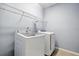 Convenient laundry room featuring a modern washer and dryer with shelving at 3925 Green Sabal Dr, Orlando, FL 32824