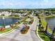 Aerial view of streetscape with manicured lawns and landscaping, water features, and the Andover Cay community entrance at 4249 Andover Cay Blvd, Orlando, FL 32825
