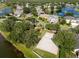 Aerial view of the community with waterfront property, mature trees, sand volleyball court and lake views at 4249 Andover Cay Blvd, Orlando, FL 32825