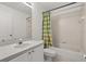 Bright bathroom featuring a shower-tub combo with a colorful curtain, a toilet, and a vanity with sink at 4249 Andover Cay Blvd, Orlando, FL 32825