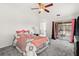 Cozy bedroom with soft carpet, a ceiling fan, and sliding glass doors leading to the backyard at 4249 Andover Cay Blvd, Orlando, FL 32825