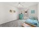 Bright bedroom featuring a ceiling fan, nautical accents, and a cozy window seat at 4249 Andover Cay Blvd, Orlando, FL 32825