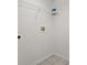 A simple closet features white wire shelving, white walls, neutral tile flooring, and hookups for a washer and dryer at 4249 Andover Cay Blvd, Orlando, FL 32825