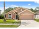 Charming single-story home with a well-manicured lawn and a two-car garage at 4249 Andover Cay Blvd, Orlando, FL 32825