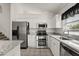 Modern kitchen featuring stainless steel appliances, granite countertops, and white cabinets at 4249 Andover Cay Blvd, Orlando, FL 32825