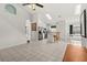 Bright open-concept living space with tile floors, an open staircase, and a modern kitchen with a skylight at 4249 Andover Cay Blvd, Orlando, FL 32825