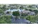 Aerial view of the community showcasing lush trees, a pool, and a serene lake with a fountain at 4704 Walden Cir # 21, Orlando, FL 32811