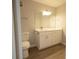 Bright bathroom features a white vanity with updated hardware and a modern light fixture at 4704 Walden Cir # 21, Orlando, FL 32811