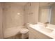 Bathroom with marble-look shower and tub, white vanity, stainless faucet and light-wood look flooring at 4704 Walden Cir # 21, Orlando, FL 32811