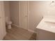 Bathroom featuring white countertop and cabinets, with a toilet and white doors nearby at 4704 Walden Cir # 21, Orlando, FL 32811