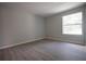 Bright, spacious bedroom featuring sleek floors and a large window overlooking the yard at 4704 Walden Cir # 21, Orlando, FL 32811
