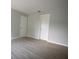Neutral bedroom showcasing laminate flooring, two closets, and simple design at 4704 Walden Cir # 21, Orlando, FL 32811