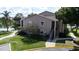 Exterior view of the multi-Gathering dwelling with stairs leading to the front door and lush landscaping at 4704 Walden Cir # 21, Orlando, FL 32811