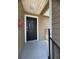 Unit 1921 has a clean black front door with a white trim and a gray concrete entry area at 4704 Walden Cir # 21, Orlando, FL 32811
