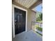 Unit 1921 has a clean black front door with a white trim and a gray concrete entry area at 4704 Walden Cir # 21, Orlando, FL 32811