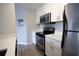 Kitchen featuring stainless steel appliances, white cabinets, and light countertops at 4704 Walden Cir # 21, Orlando, FL 32811