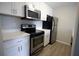 Kitchen showcasing stainless steel appliances, white cabinets, and light countertops at 4704 Walden Cir # 21, Orlando, FL 32811