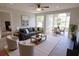 Open living room with hardwood floors, ceiling fan, and large windows at 4704 Walden Cir # 21, Orlando, FL 32811