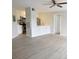 Open living room with hardwood floors and bright white kitchen at 4704 Walden Cir # 21, Orlando, FL 32811