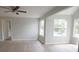 Large living room with hardwood floors, ceiling fan, and many windows at 4704 Walden Cir # 21, Orlando, FL 32811