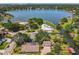 Majestic aerial view captures stunning lakeside properties with private docks, swimming pools, and lush green surroundings at 5127 Leeward Way, Orlando, FL 32809