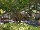 Inviting backyard patio with screened-in porch, mature trees, and charming outdoor seating area at 5127 Leeward Way, Orlando, FL 32809