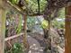 Path and pergola entwined with vines and greenery, creating a serene backyard escape at 5127 Leeward Way, Orlando, FL 32809