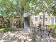 Backyard patio area with outdoor seating, lush greenery, and charming pergola at 5127 Leeward Way, Orlando, FL 32809
