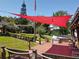 Backyard showing a boat dock, lovely lawn, patio furniture covered by a red shade at 5127 Leeward Way, Orlando, FL 32809