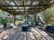 Cozy backyard patio with a vine-covered pergola, perfect for outdoor lounging and entertaining at 5127 Leeward Way, Orlando, FL 32809