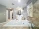 Bright bathroom with tile floor, soaking tub, vanity, and decorative wall art at 5127 Leeward Way, Orlando, FL 32809