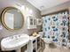 Bathroom featuring a toilet, sink, and mirror at 5127 Leeward Way, Orlando, FL 32809